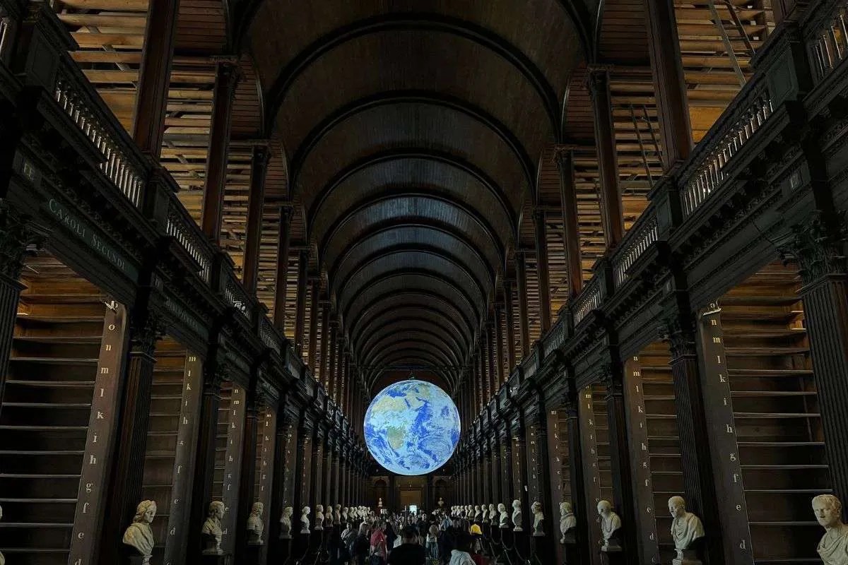 The trinity library in Ireland with the floating globe and empty bookshelves.