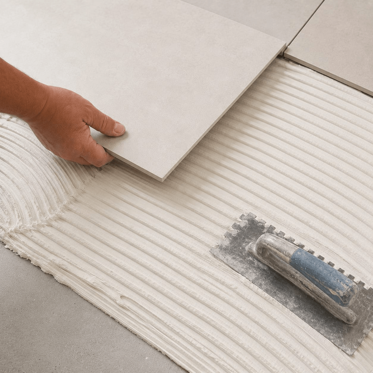 Large porcelain floor tile installation with tile adhesive