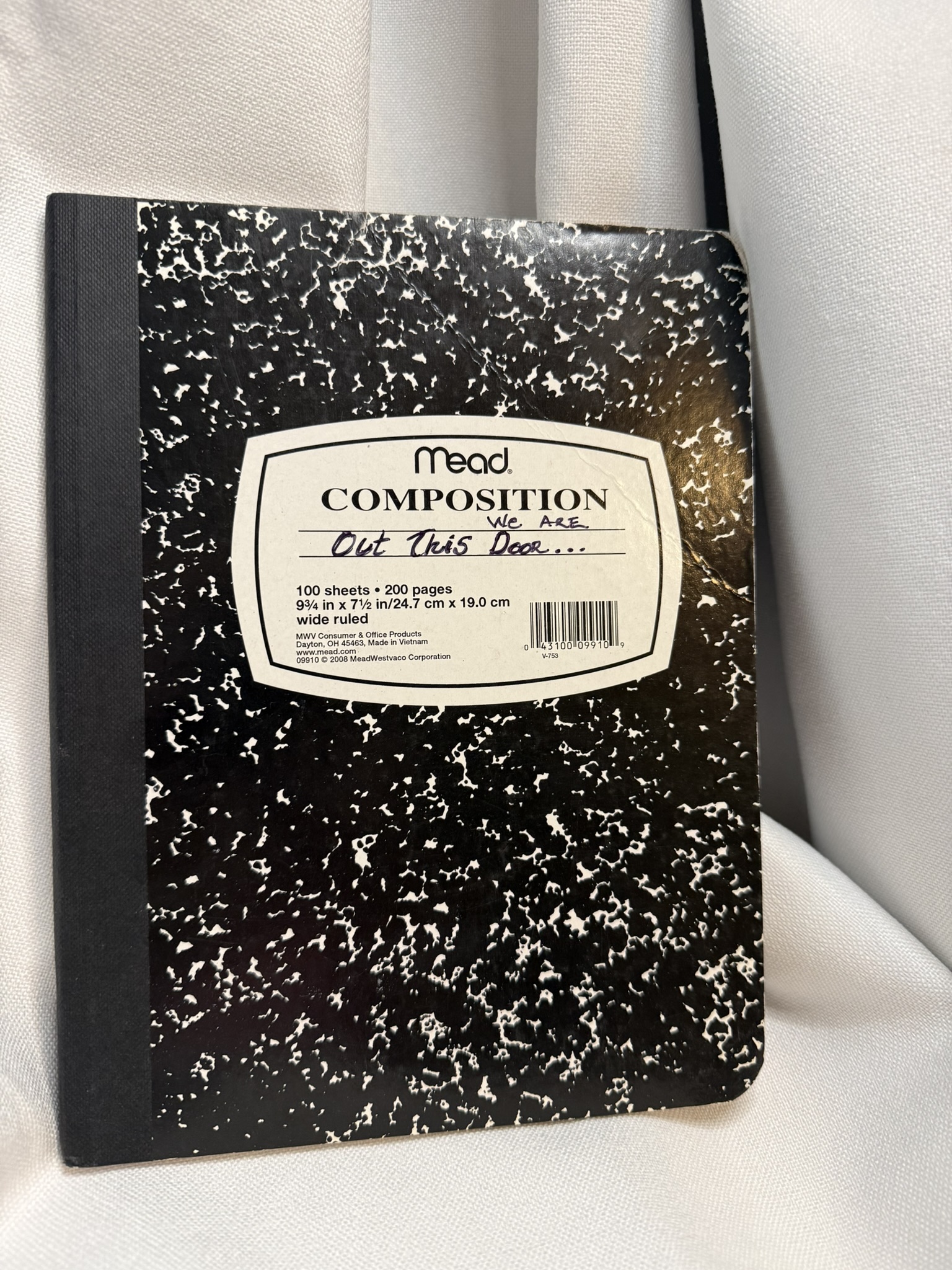 a black and white composition notebook on a white background