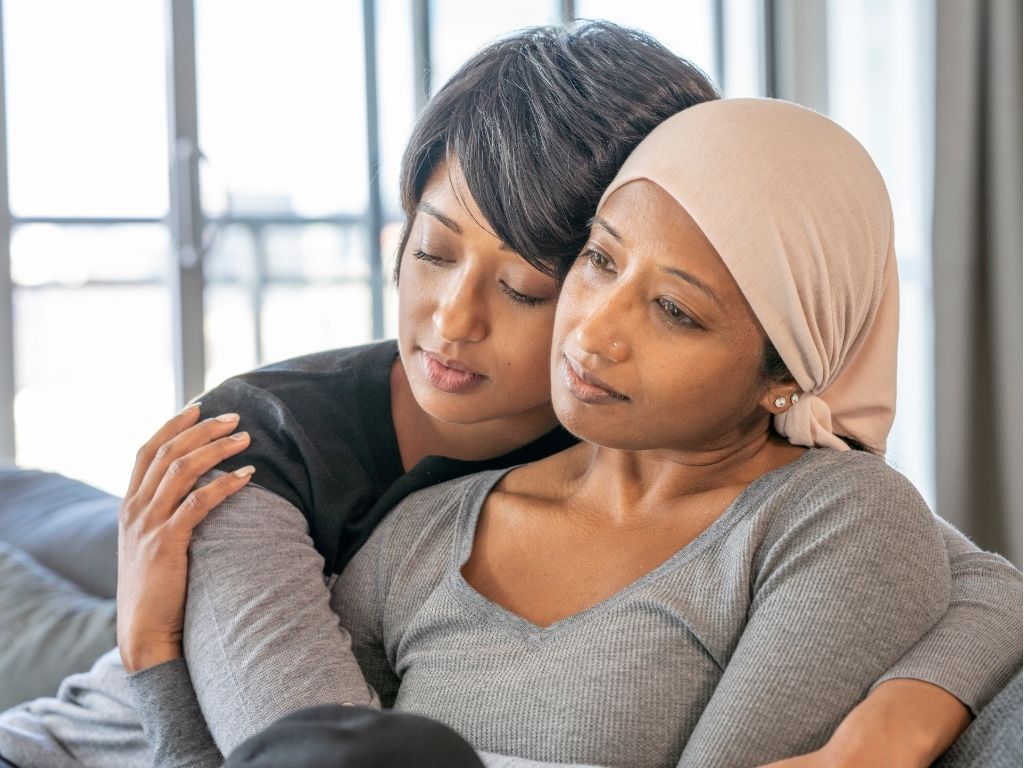 Ovarian cancer patient and caregiver embrace