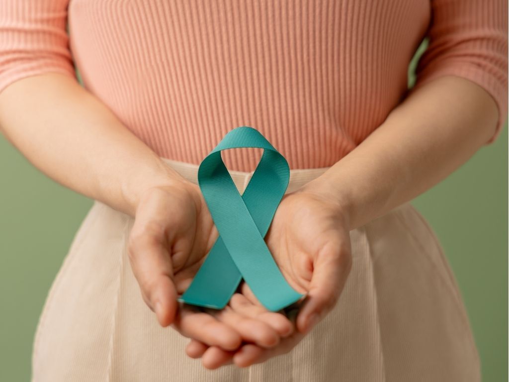 Ovarian cancer patient holding an awareness ribbon.