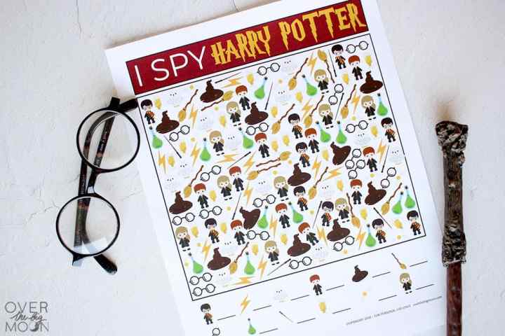 The printable Game I Spy Harry Potter on a white backdrop with Harry Potter glasses and a wand next to it.