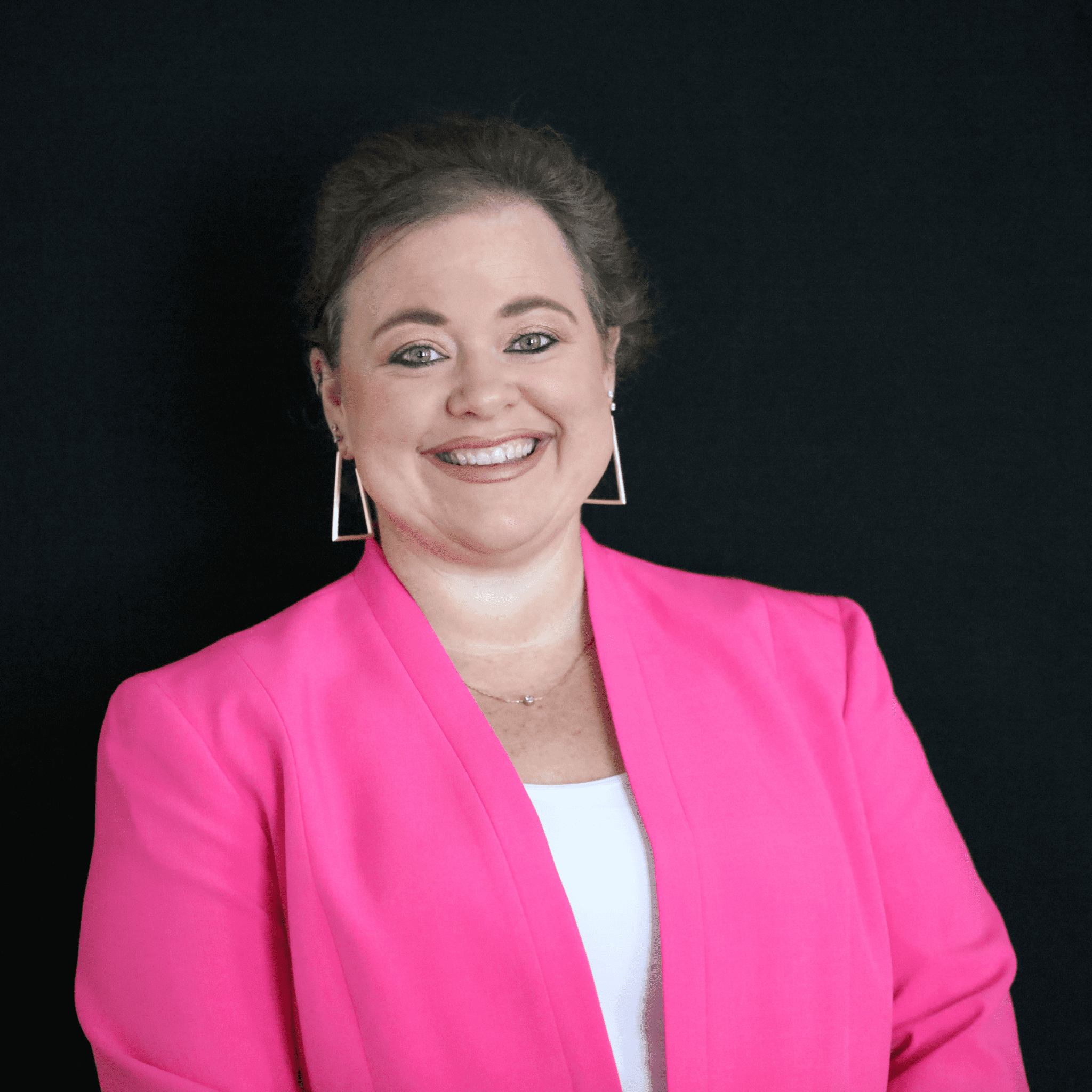 Woman in pink blazer with a smile