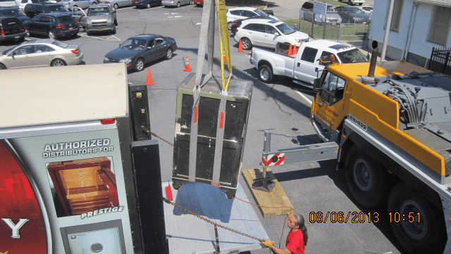 Challenging safe removal from room with use of a crane
