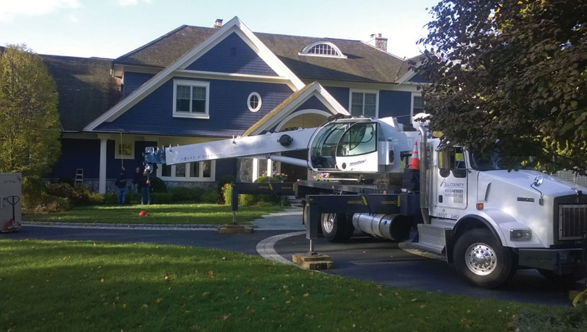 Using boom to move a safe into a home
