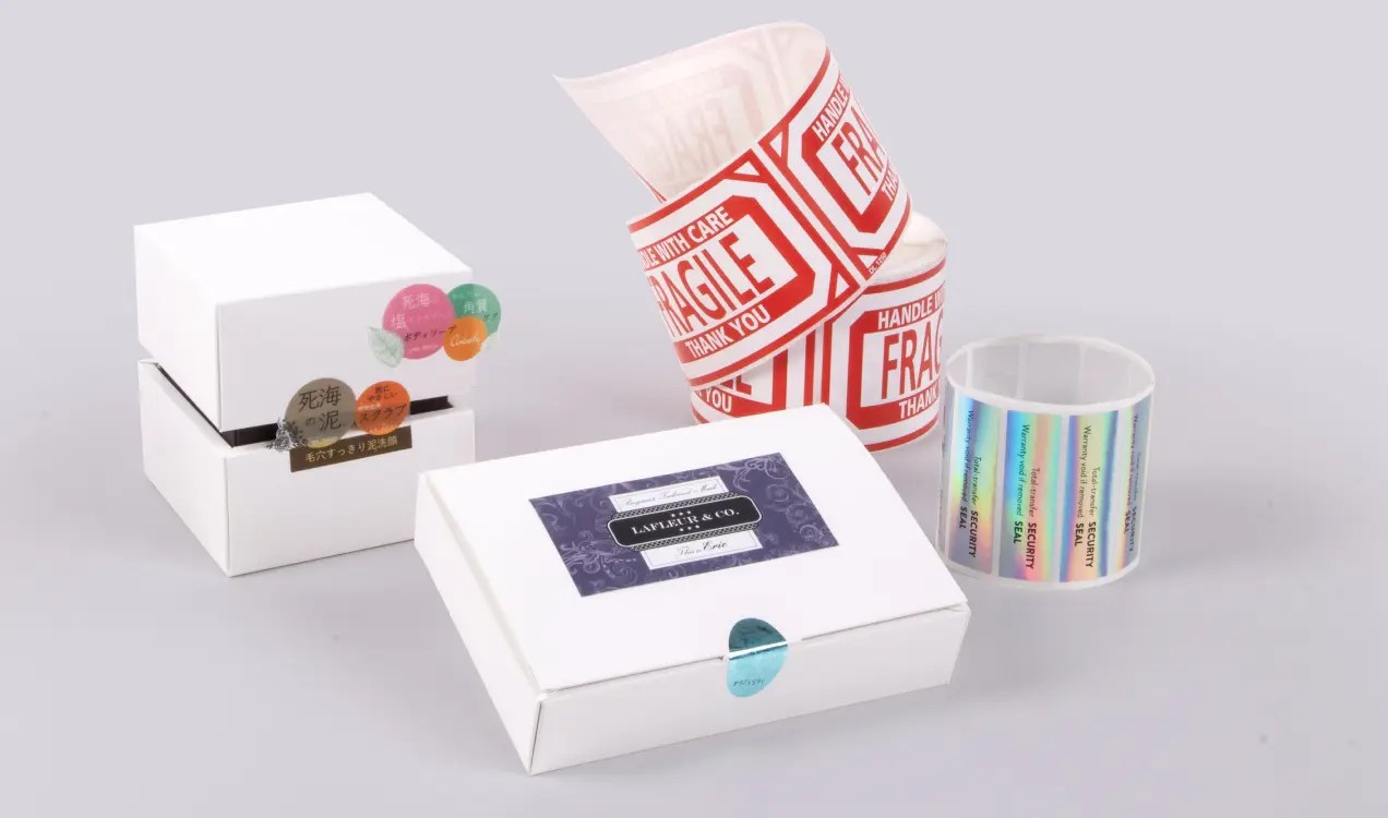 Custom stickers displayed on packaging boxes with various colorful label designs