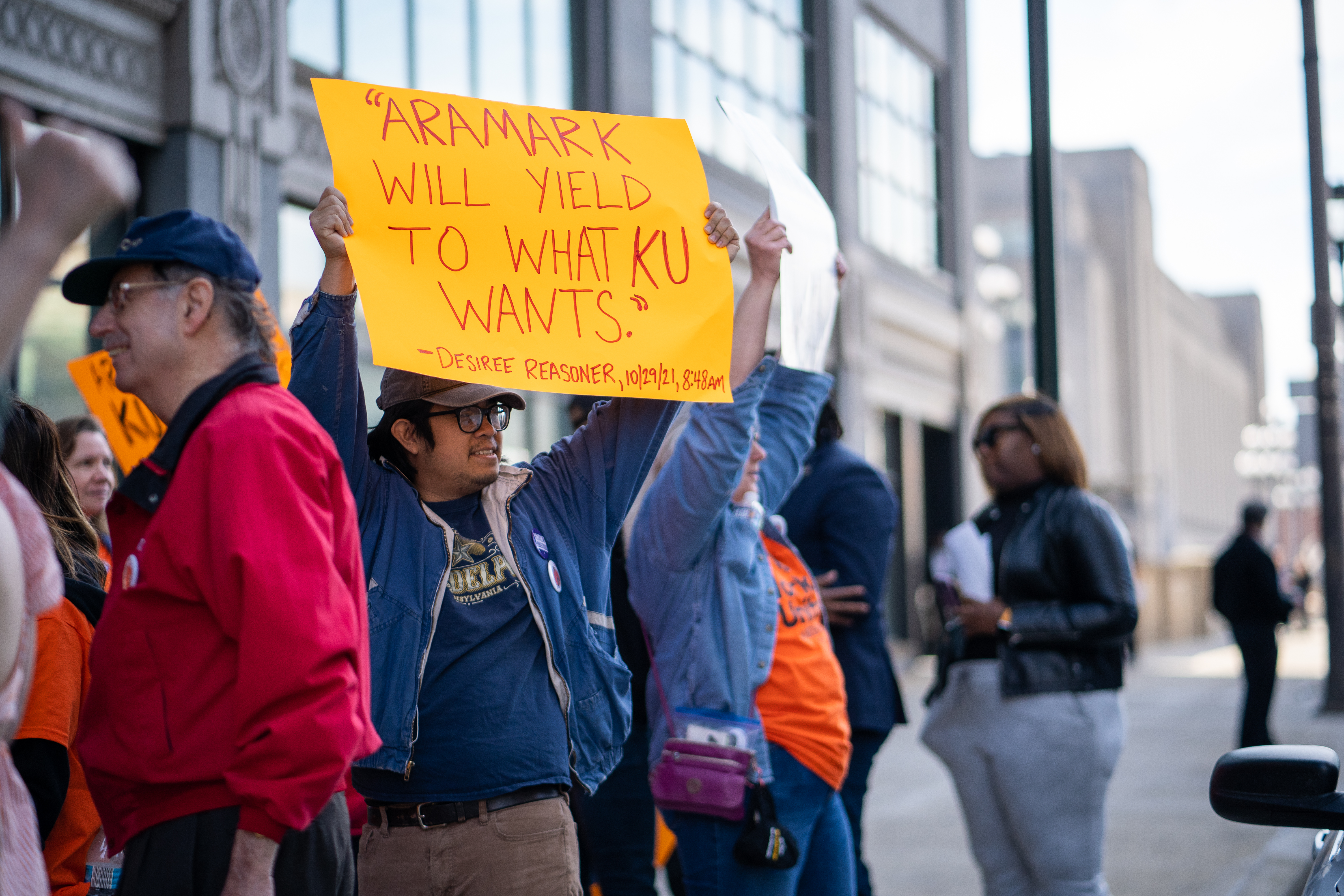 Supporter at Philadelphia's 3/15 rally holds a sign reading, "Aramark will yield to what KU wants."