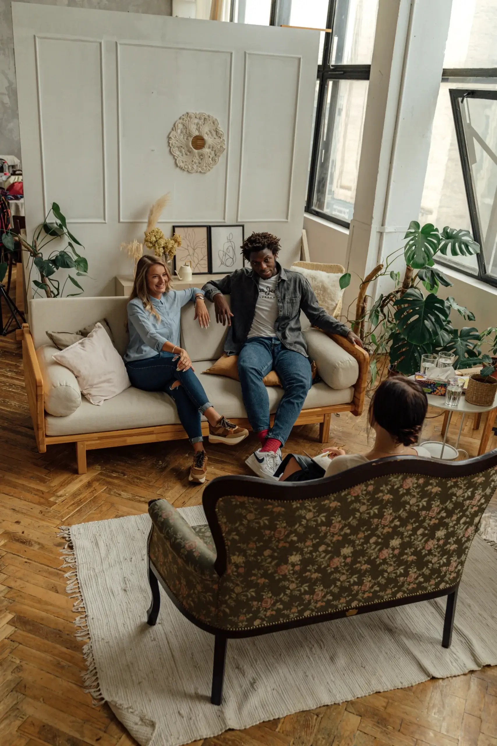 A therapist meeting with a couple during a trauma-informed couples therapy session to improve communication, emotional safety, and relationship healing.