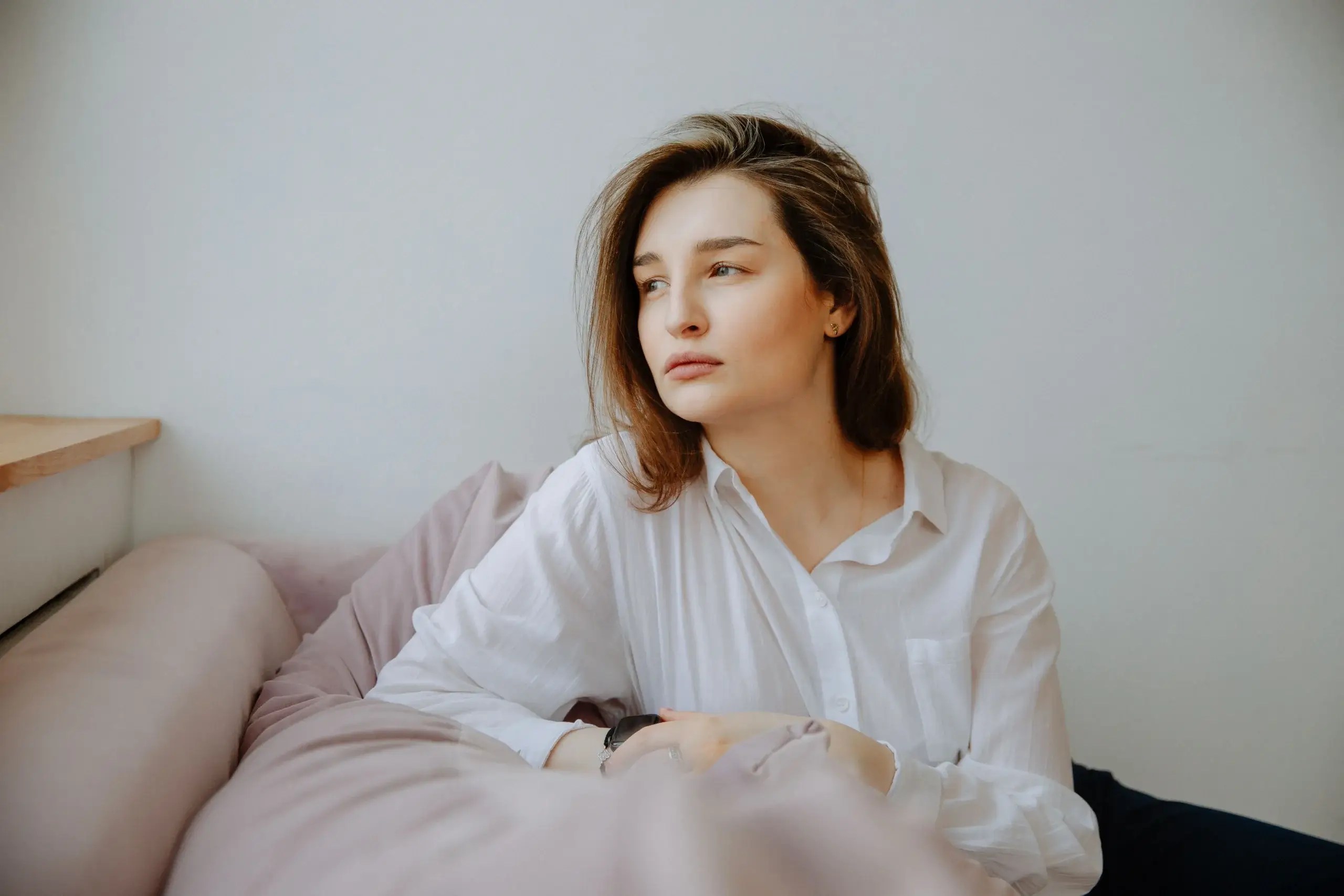 Person sitting in quiet reflection, representing self-awareness and understanding your nervous system before responding to relationship anxiety.