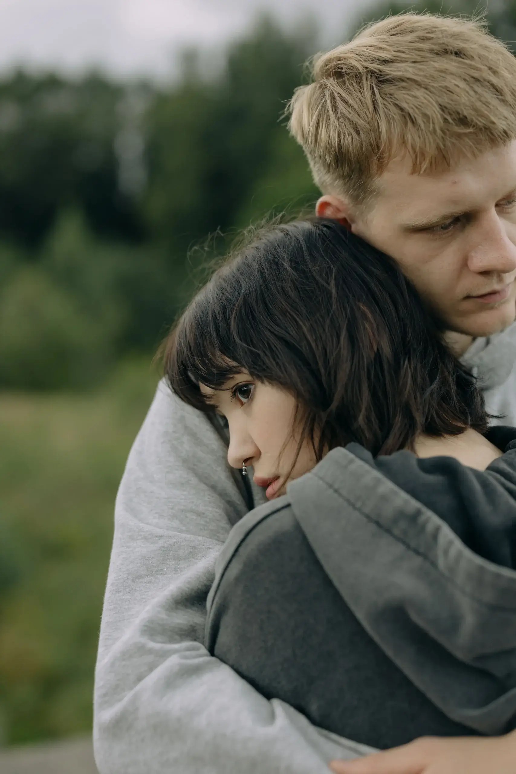 Couple embracing while experiencing emotional distress and relationship challenges