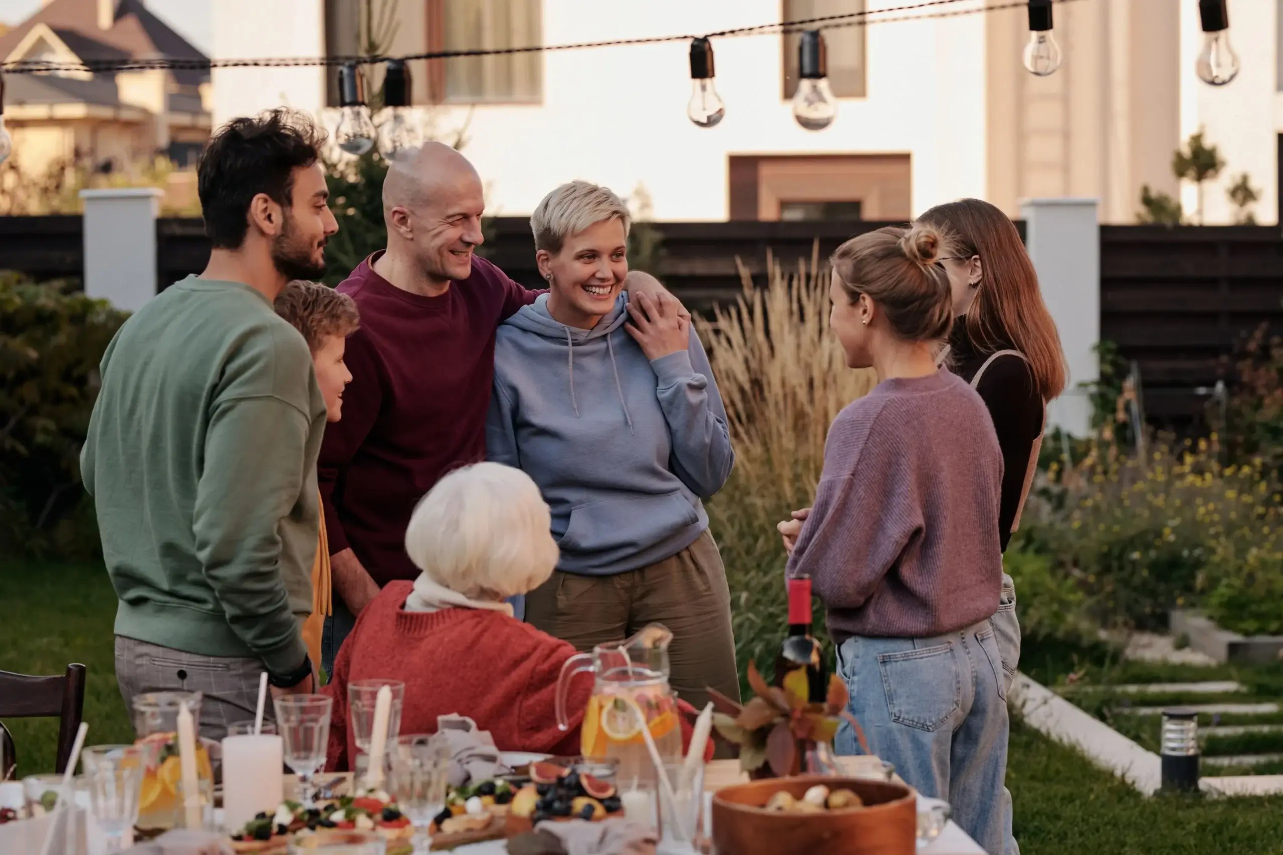 Family gathered together outdoors for a meal and conversation