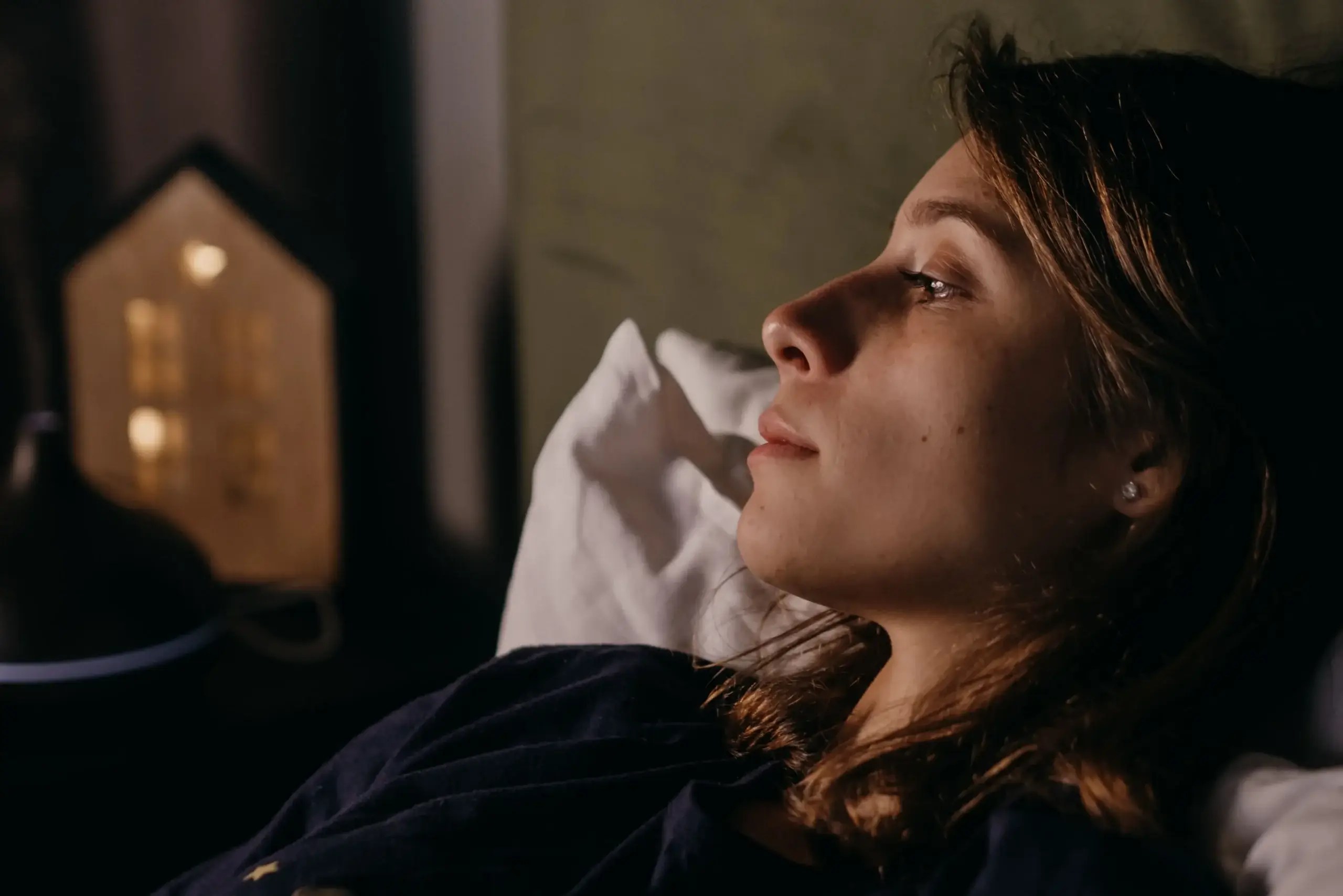 Woman lying awake in bed and reflecting
