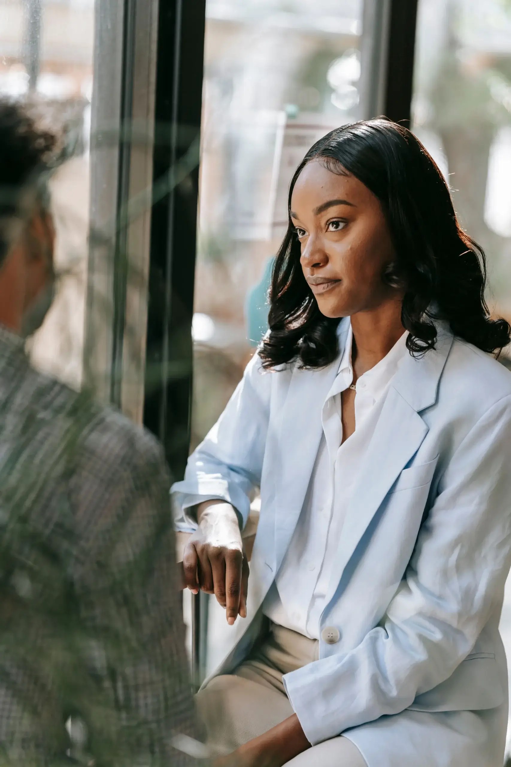 Therapist listening attentively to a client during a conversation in a comfortable setting.