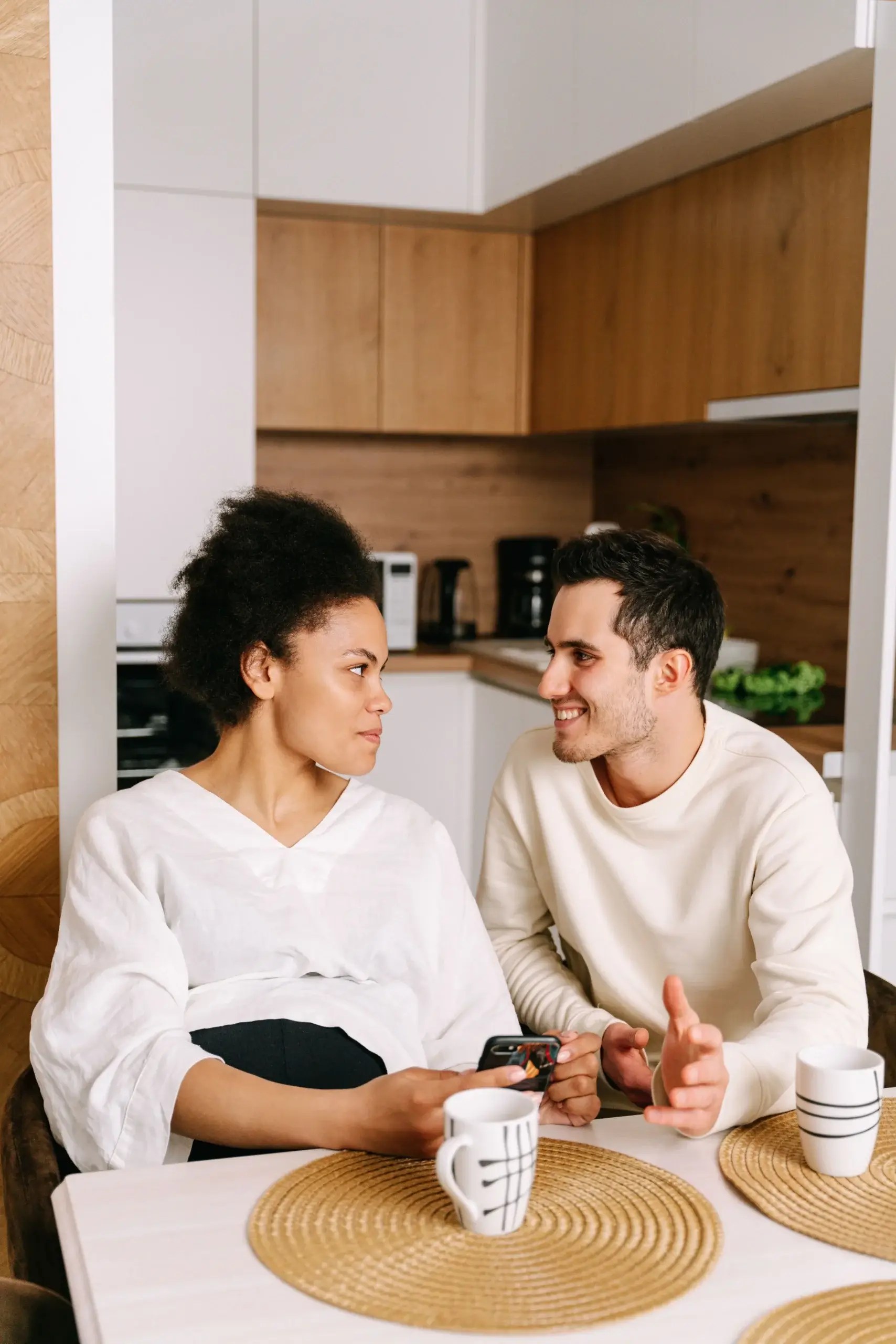 Couple having a thoughtful conversation about emotional responses and relationship accountability.