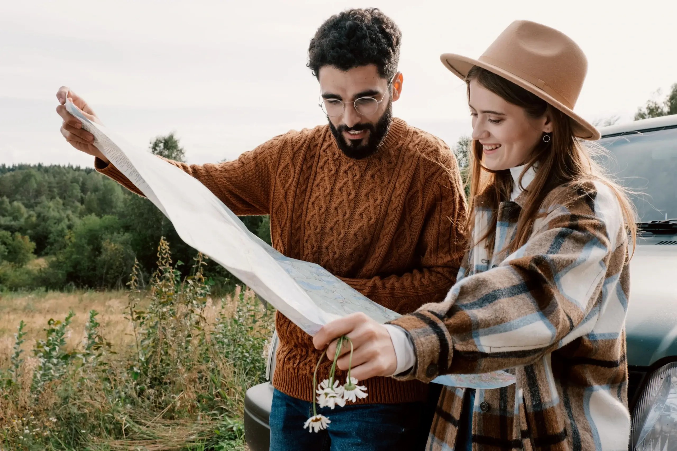Couple exploring a new destination together while looking at a map.