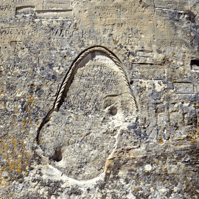 The carved rope circles the signatures of a whole platoon.