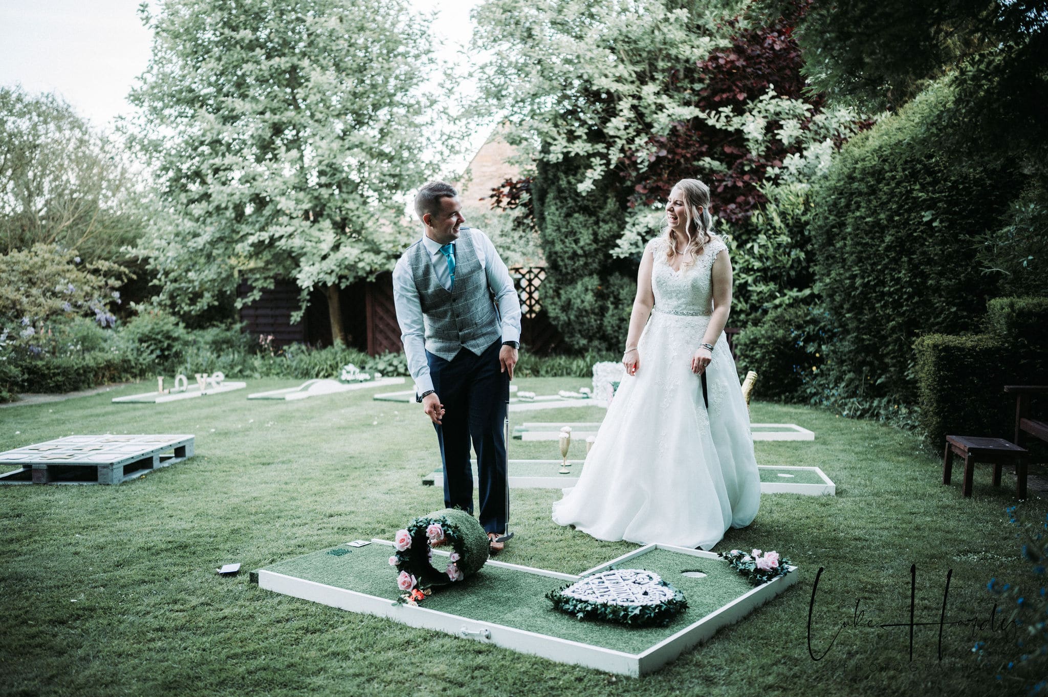 ALT="bride and groom playing crazy golf wedding hire at Cotswold house hotel"