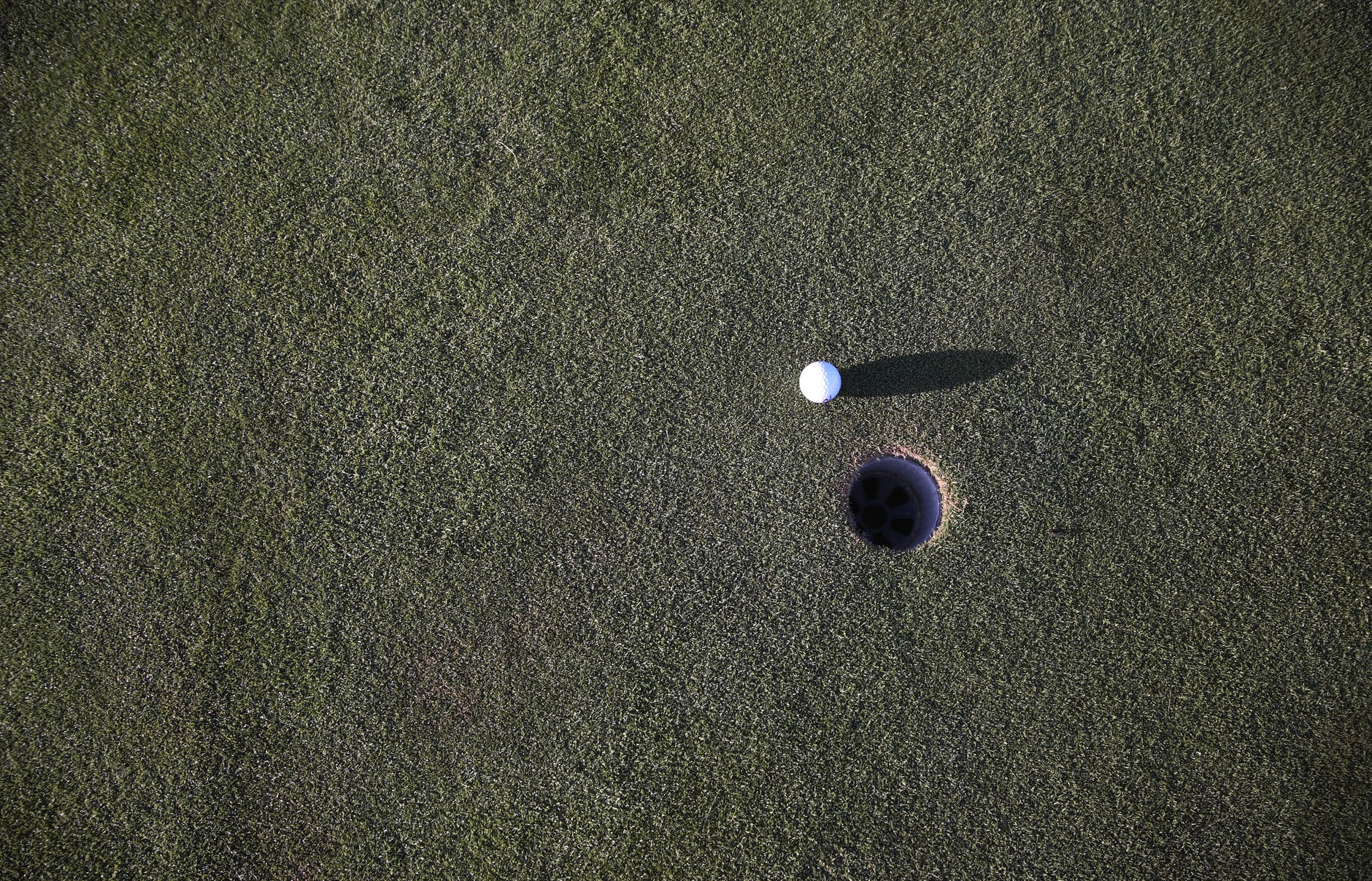 white round golf ball on green grass field