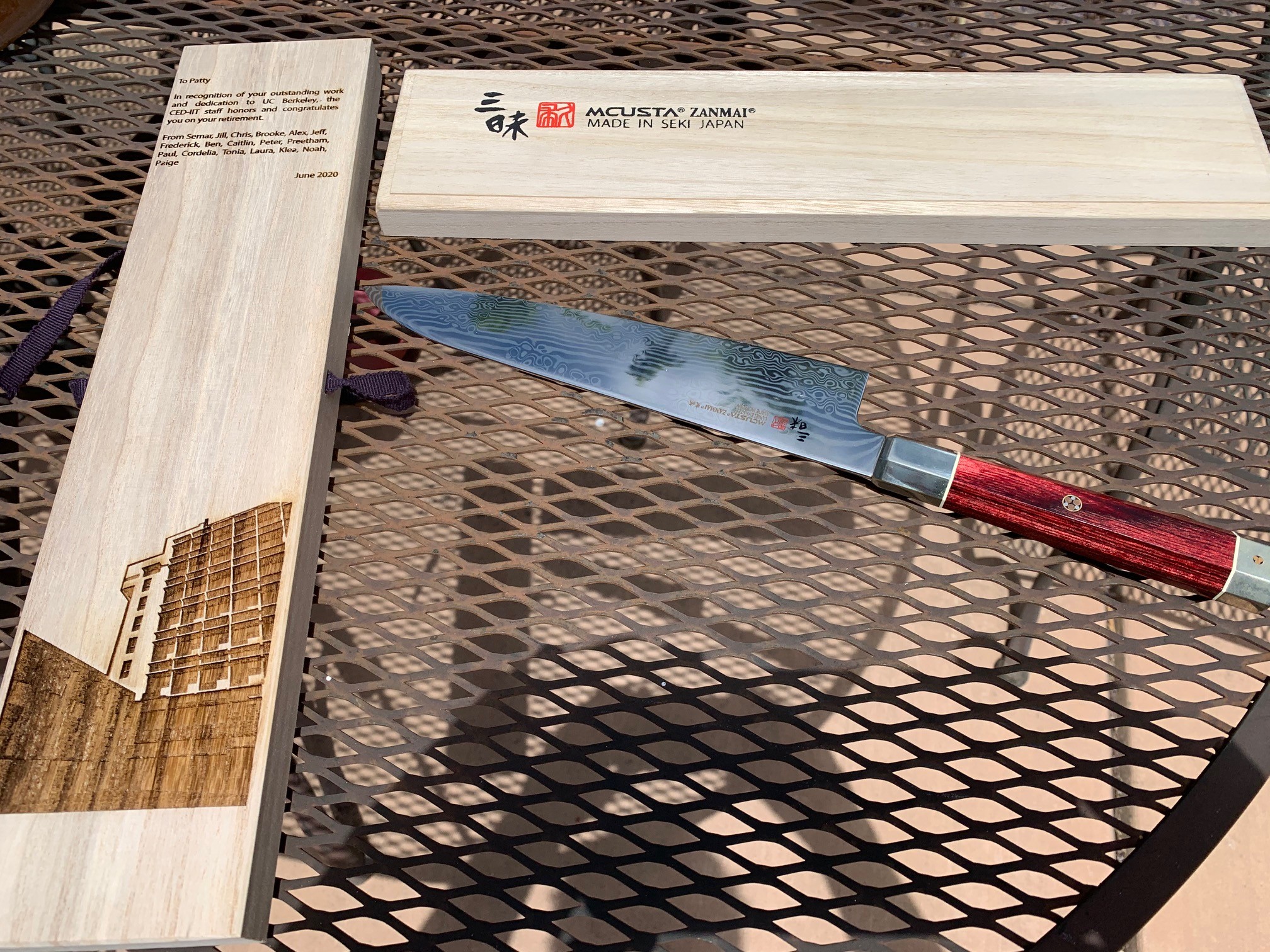 Photo of a chefs knife made in Japan and the engraved box it came in.
