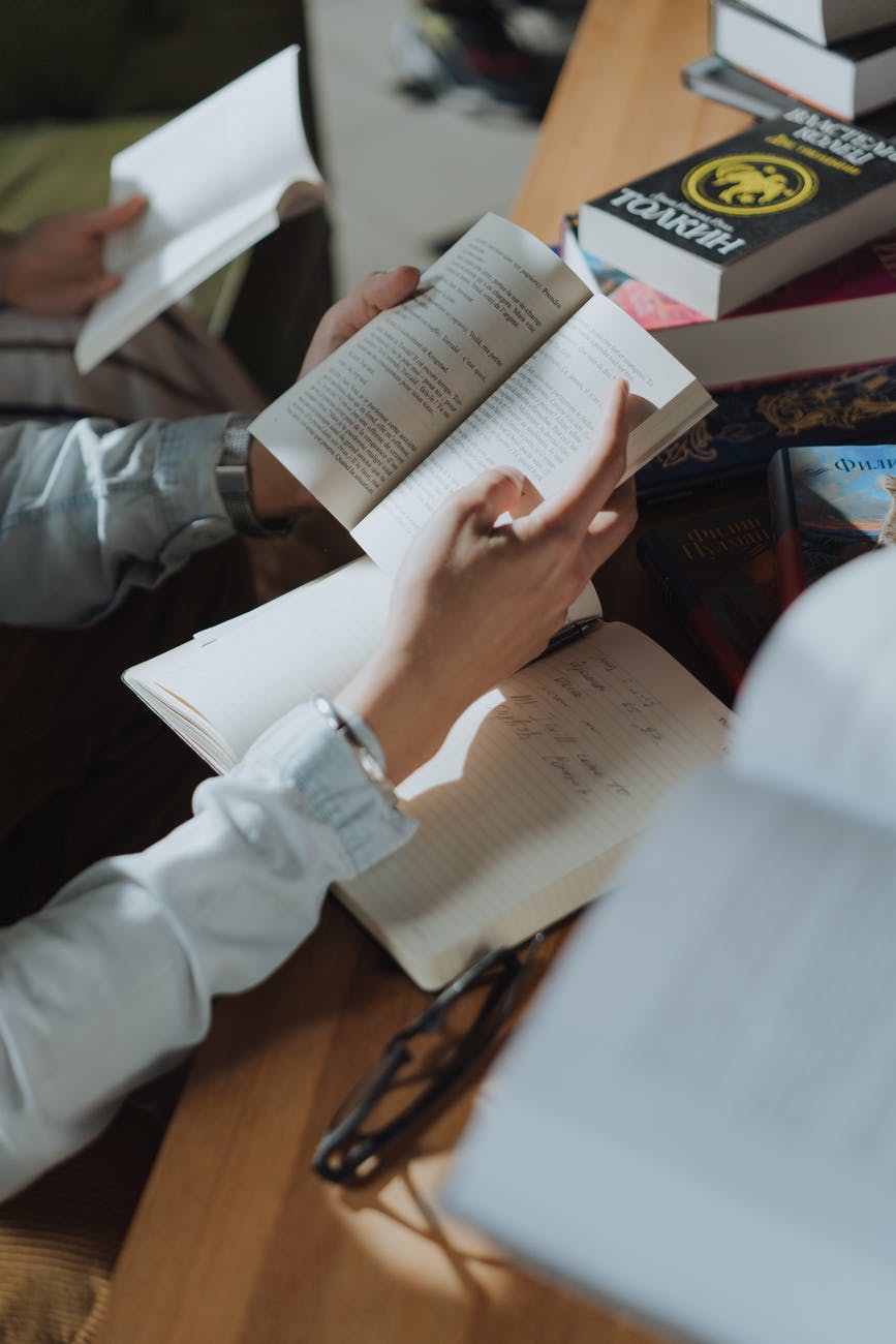 person in white long sleeve shirt holding white paper