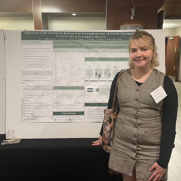 Zoe in front of her poster