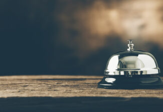 Bell of service on wood. dark filter. panoramic photo