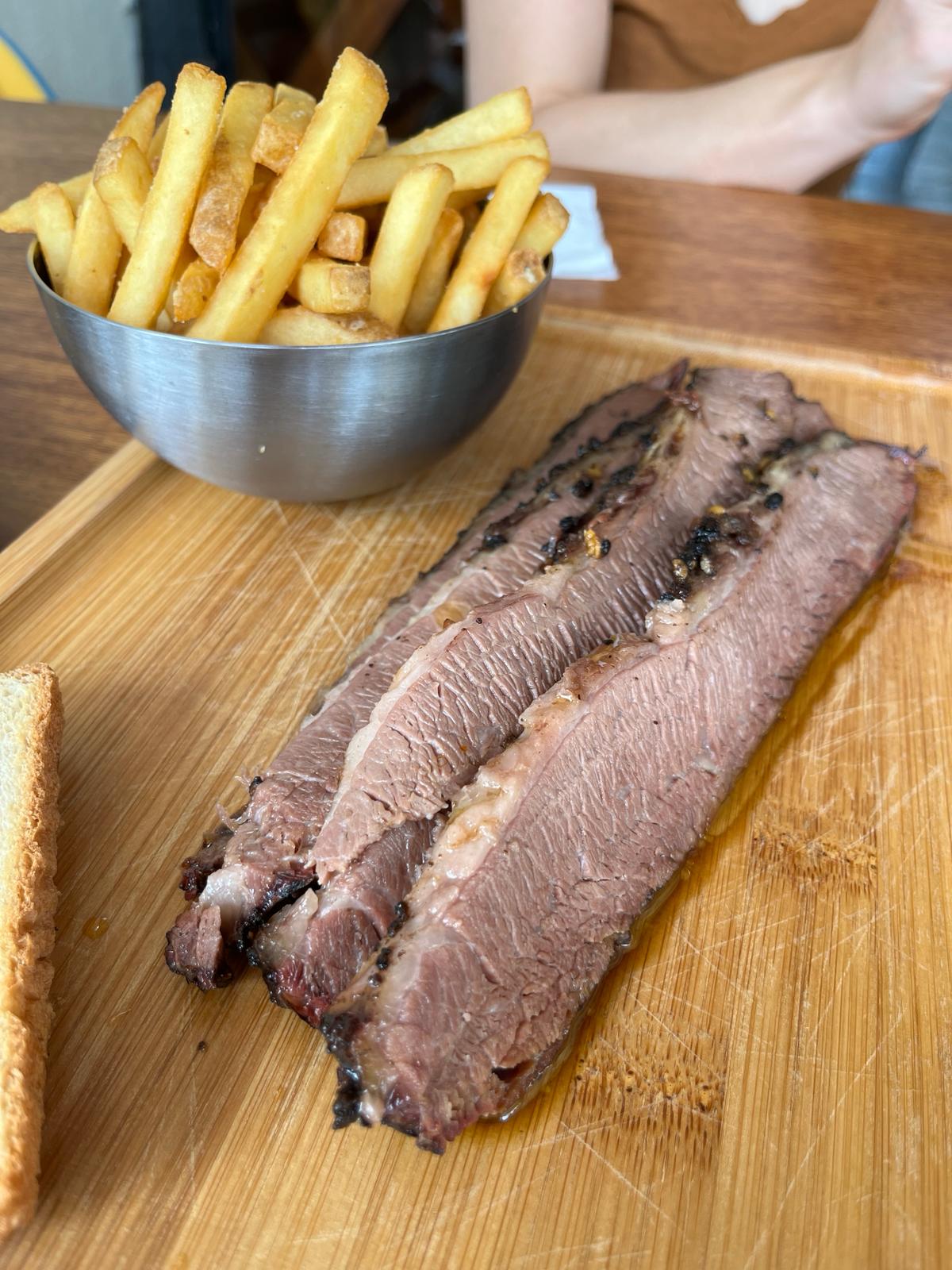 A plate of brisket and fries from a BBQ restaurant Abu Dhabi