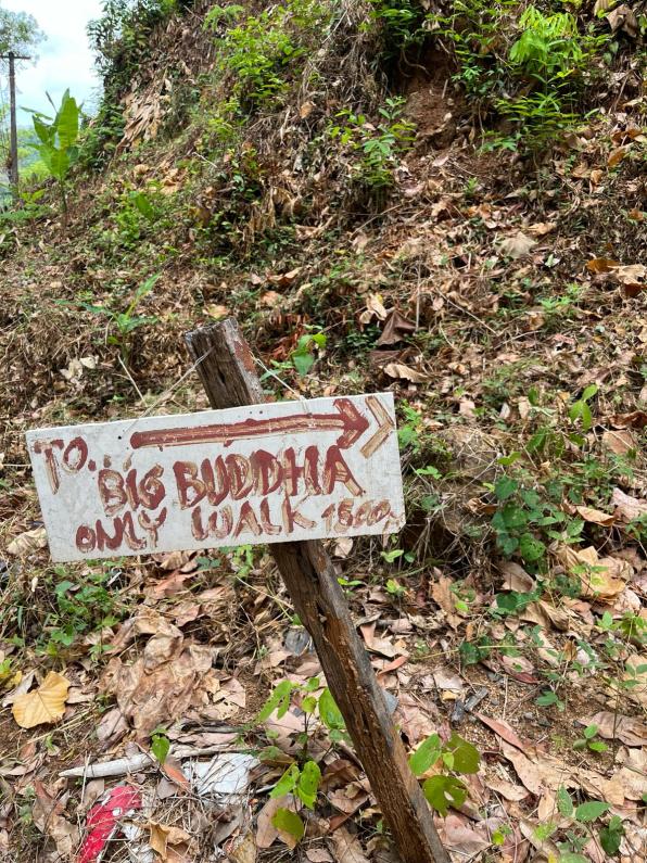 A sign pointing to the Big Buddha Phuket Thailand trail.