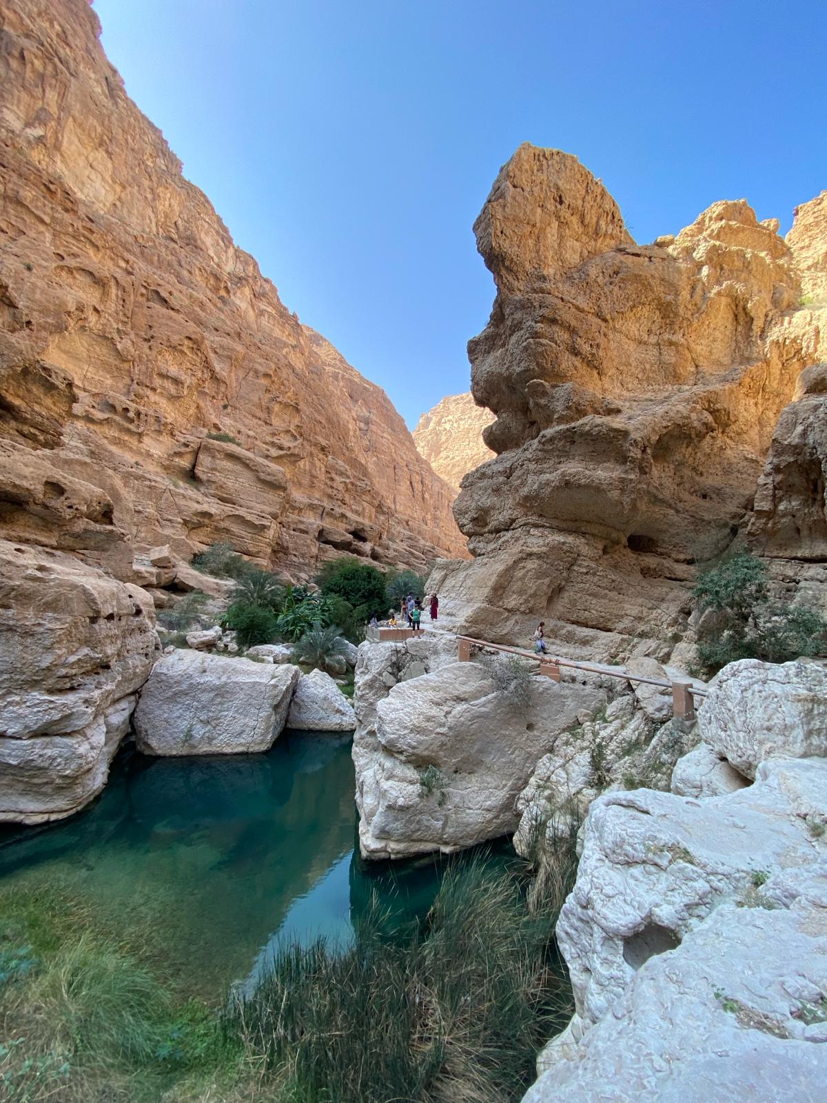 The canyon rocks and water against the blue skies at Wadi Shab