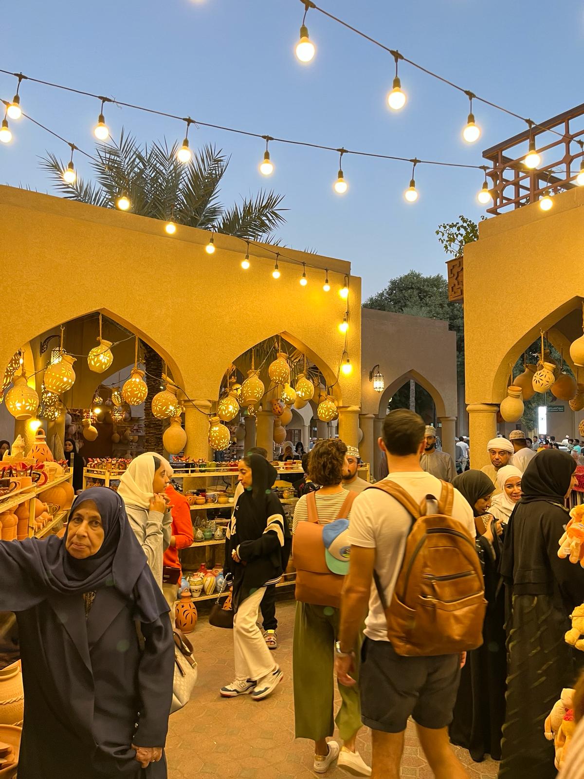 The Nizwa Souq with the market lit up at night with twinkly white lights.