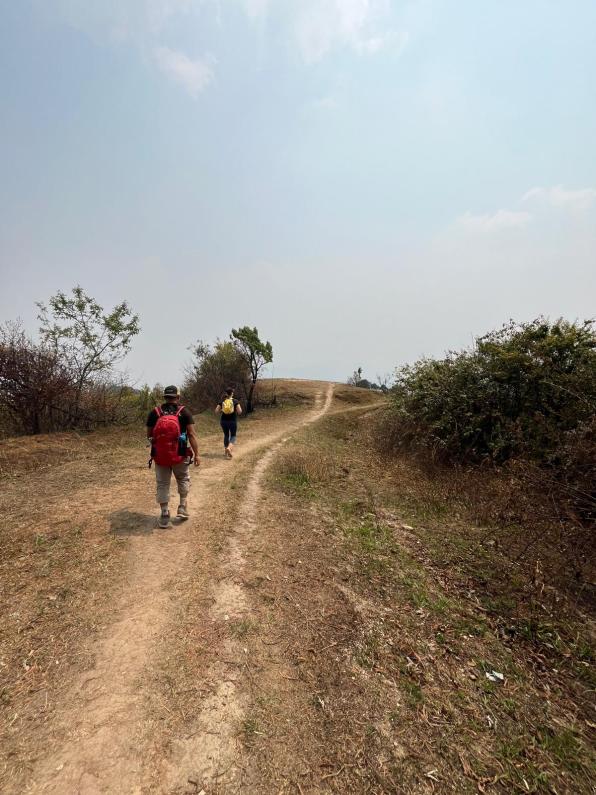 Two people hiking on a dirt path in Nepal