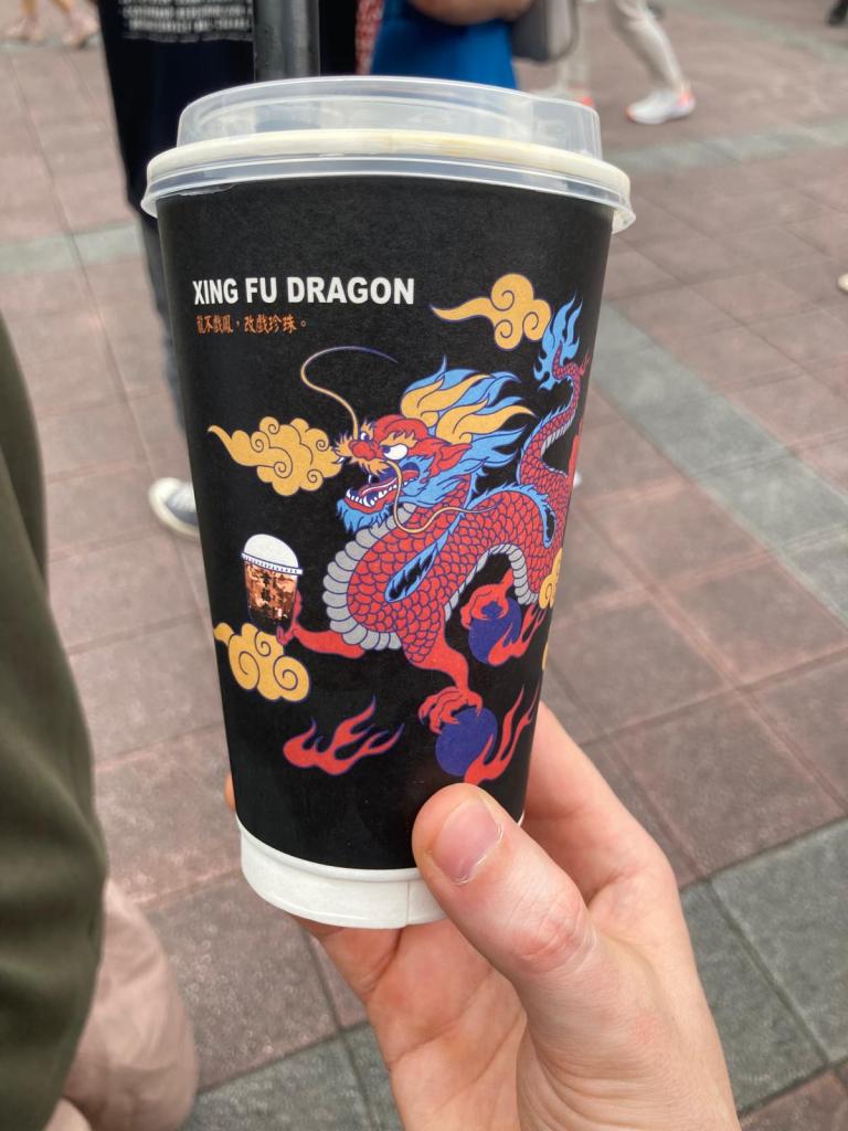 A cup of Xing Fu Bubble Tea with a dragon holding a bubble tea.