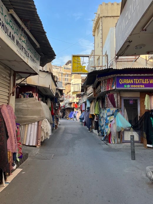 A quiet street with closed store fronts in the Bahrain Manama Souk