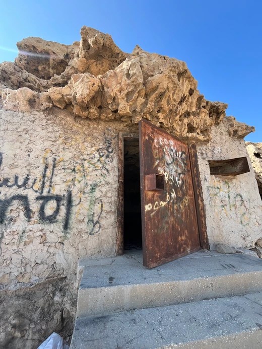 The outside of the Caves, a graffitied old prison in Bahrain.