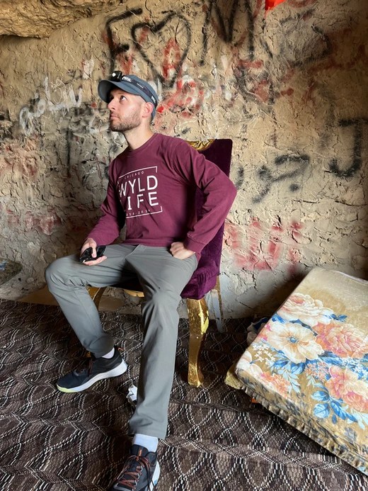 A man posing inside the Caves, a graffitied old prison.