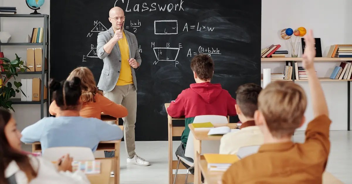Guy is teaching students in a classroom - Side Hustles for Teachers
