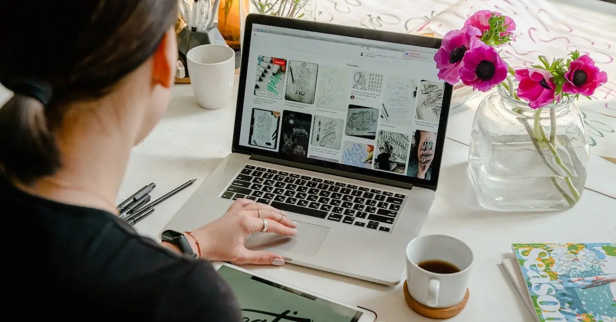 Lady is working on laptop to show the side hustles that pay weekly
