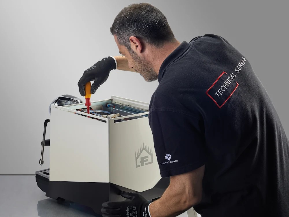 - Healthy Brew Hub Cimbali employee fixes a Faema espresso machine.