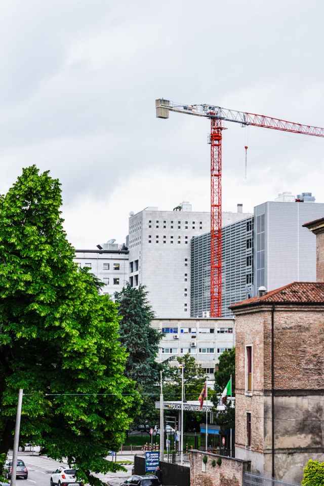 View of construction crane and buildings in Padova, Italy.