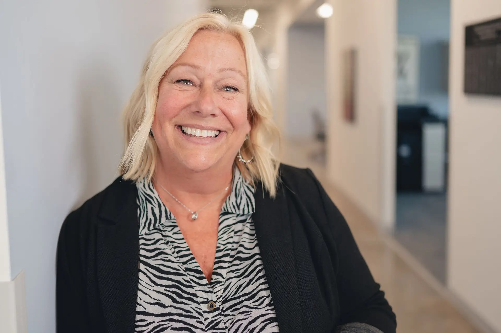 A woman smiling at camera.