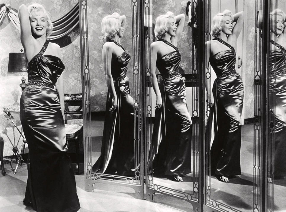 Woman viewed from several directions through reflections in multiple mirrors