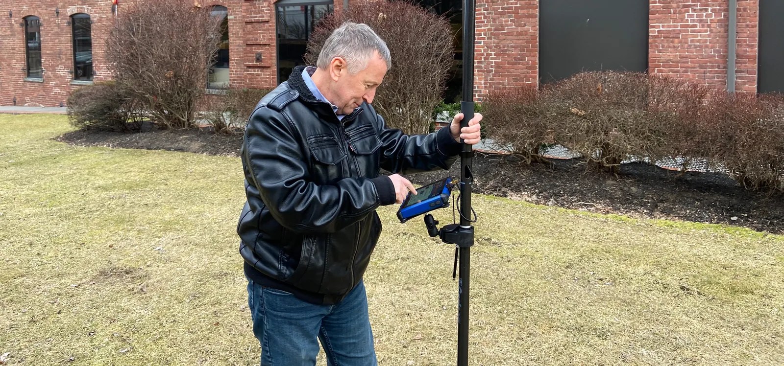 Survey professional using Carlson RTk5 data collector for field data collection