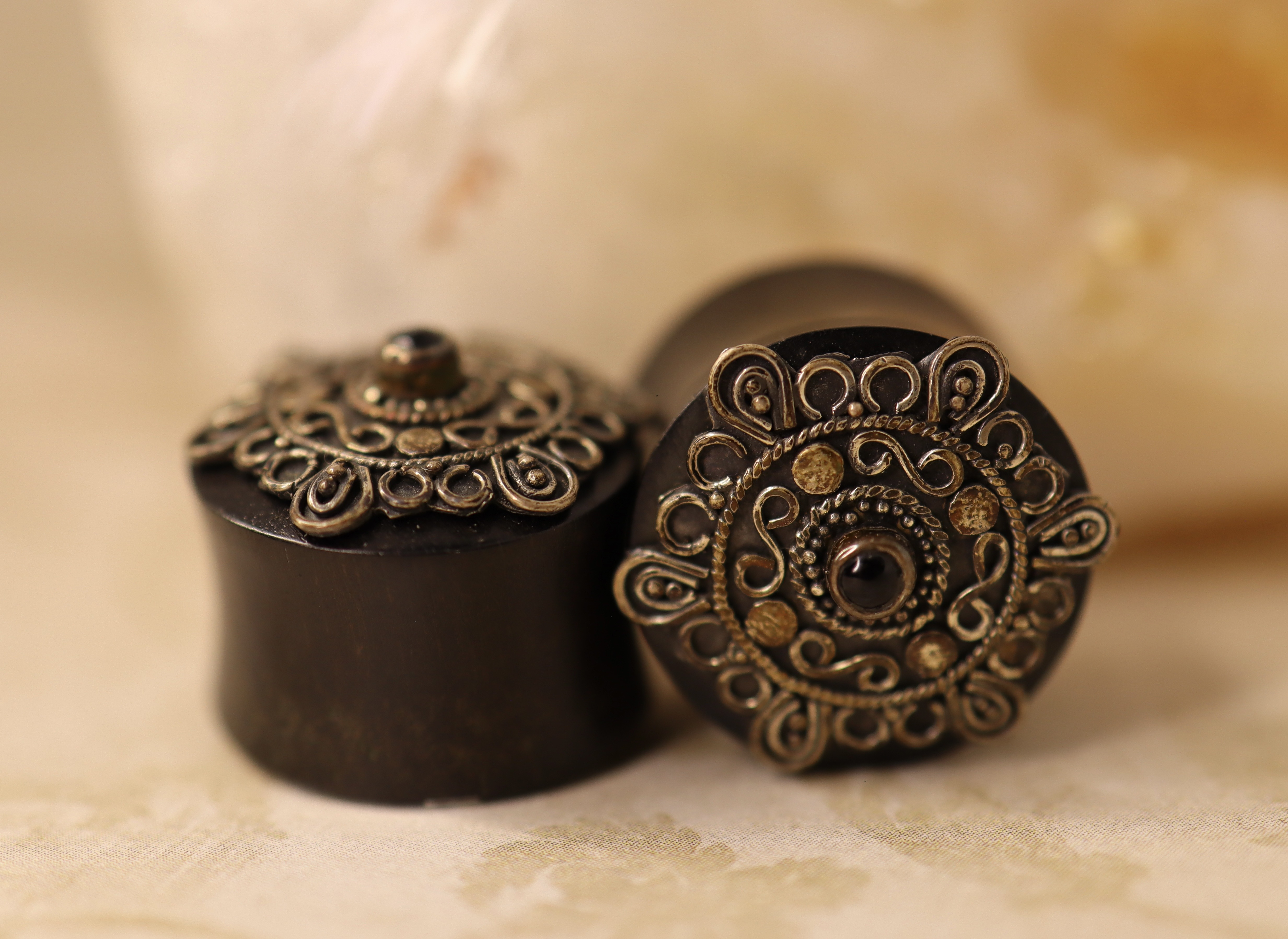 Intricate White Brass Design with Black Gem Horn Plugs