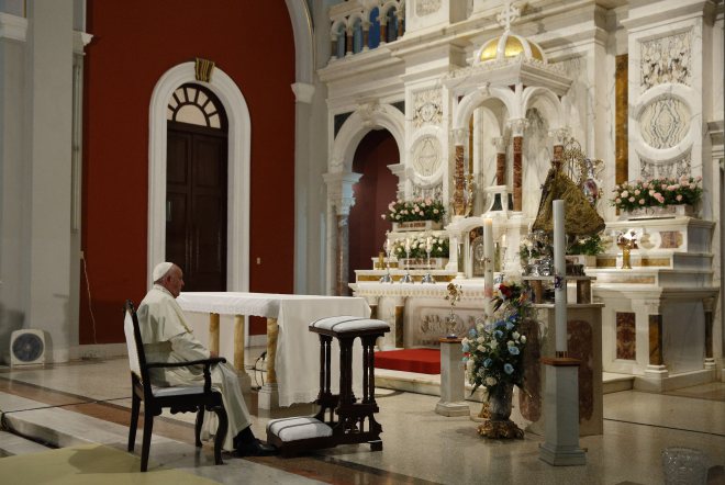 Pope Francis prays near the statue of Our Lady of Charity, patroness of Cuba, in El Cobre