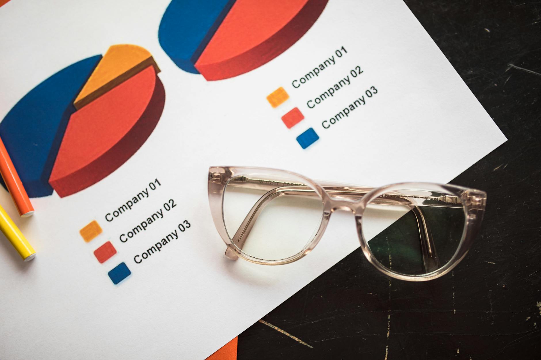 silver framed eyeglasses on white paper