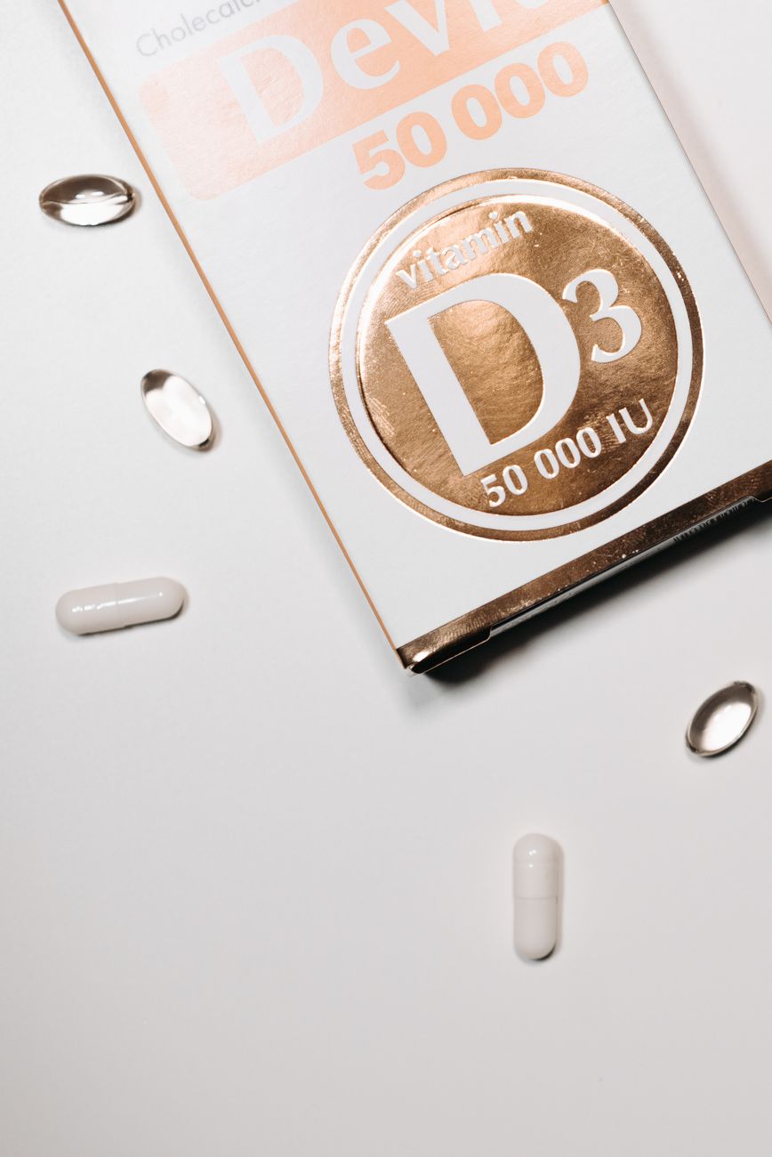 vitamin capsules beside white labeled box