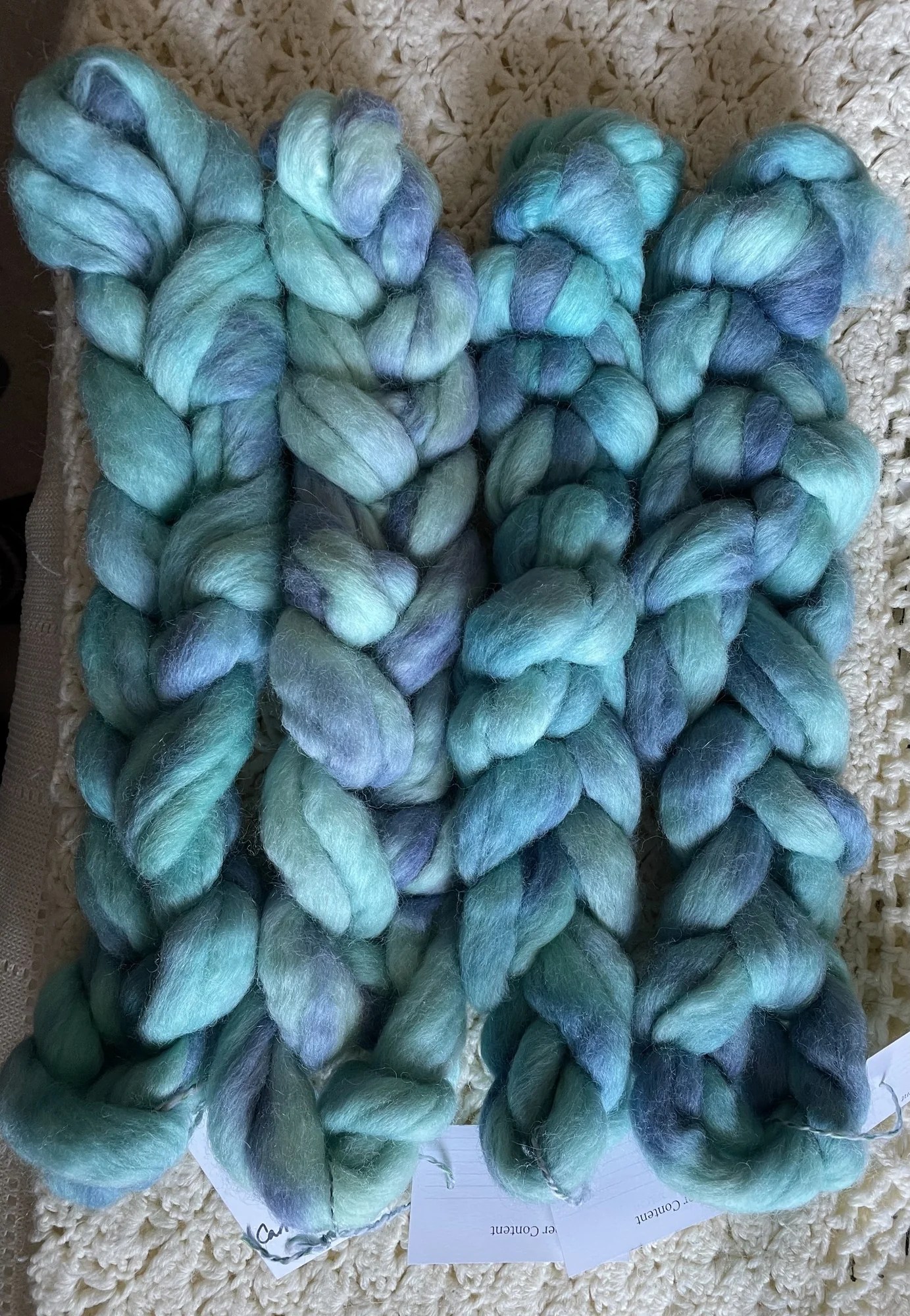 Braids of Australian Merino wool in turquoise, teal and blue-green tones.