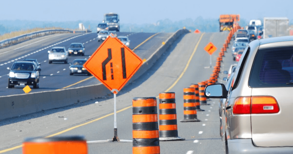 Cars move through highway construction that was funded by a private-public partnership