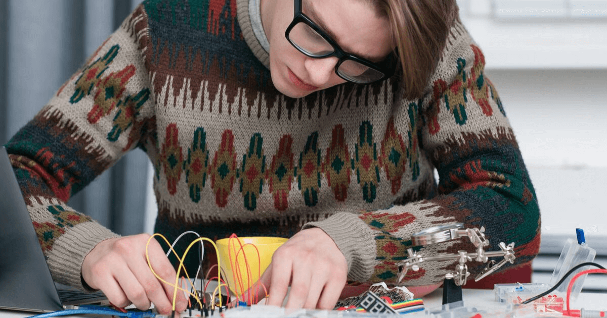An employee works on his invention, which is protected by intellectual property rights.