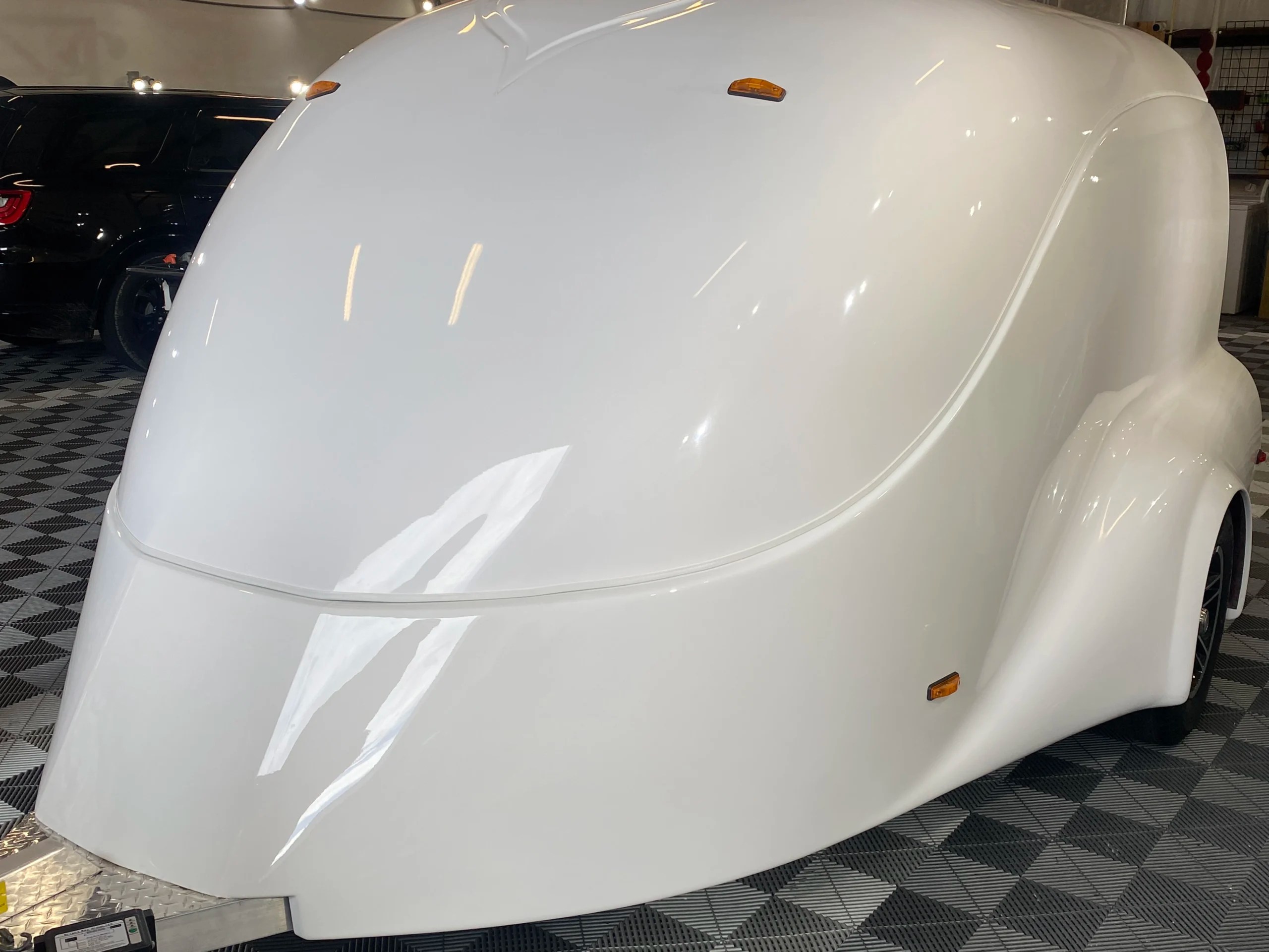 A custom built motorcycle trailer with a ceramic coating and paint protection film installed. It is sitting inside of Phoenix Detailing located in Melbourne Florida.